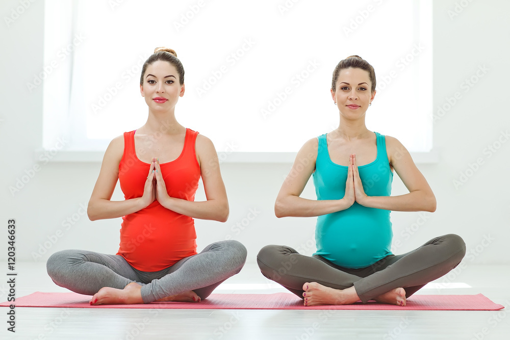 Two pregnant women making yoga