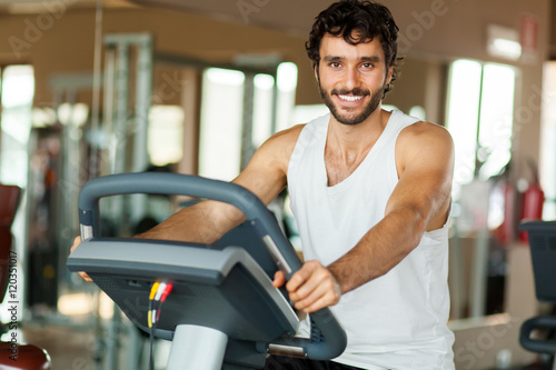 Man working out on a treadmill in a gym photo