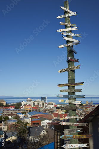Signpost to locations around the world in Punta Arenas in southern Chile overlooking the Strait of Magellan.