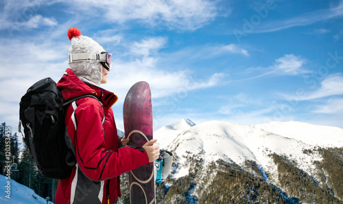 Girl standing with snowboard
