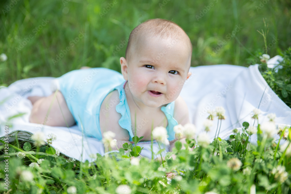 Baby girl crawling on the grass. Selective focus her eyes. Baby girl crawling on the grass. Selective focus her eyes.