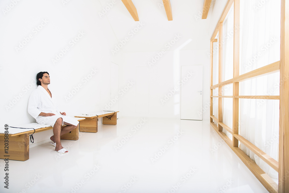 Healthy guy resting in bathrobe Healthy guy resting in bathrobe