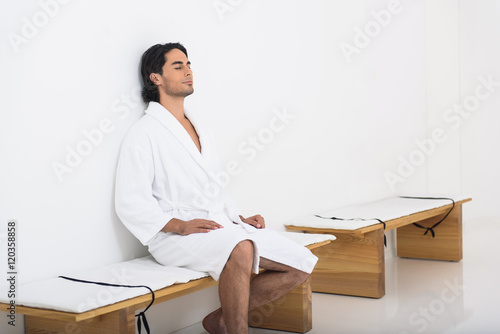 Calm guy relaxing at spa salon