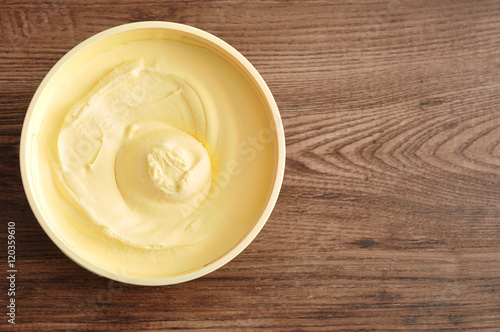 Butter isolated on a wooden background photo