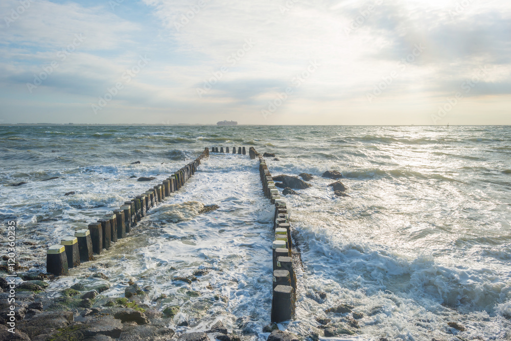 Breakwater in a stormy sea in summer