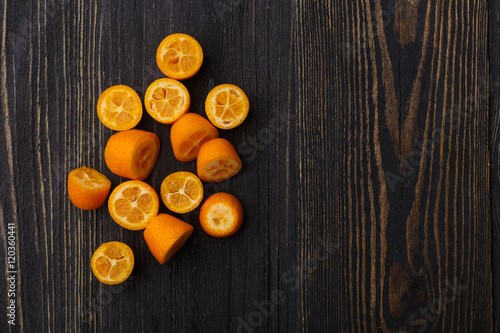 kumquat on a black wooden background 