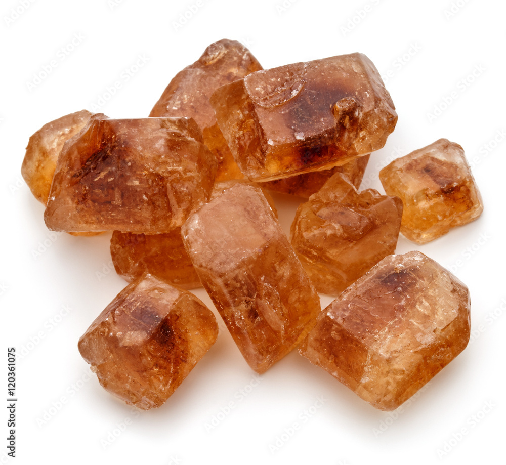 Brown caramelized lump cane sugar cube isolated on white backgro Brown caramelized lump cane sugar cube isolated on white backgro