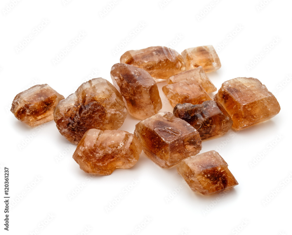 Brown caramelized lump cane sugar cube isolated on white backgro Brown caramelized lump cane sugar cube isolated on white backgro