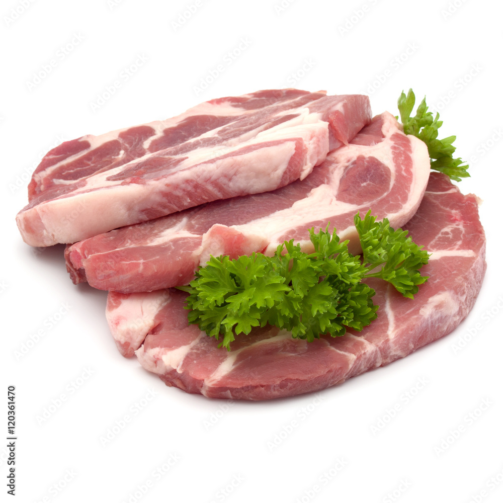 Raw pork neck chop meat with parsley herb leaves garnish isolate Raw pork neck chop meat with parsley herb leaves garnish isolate