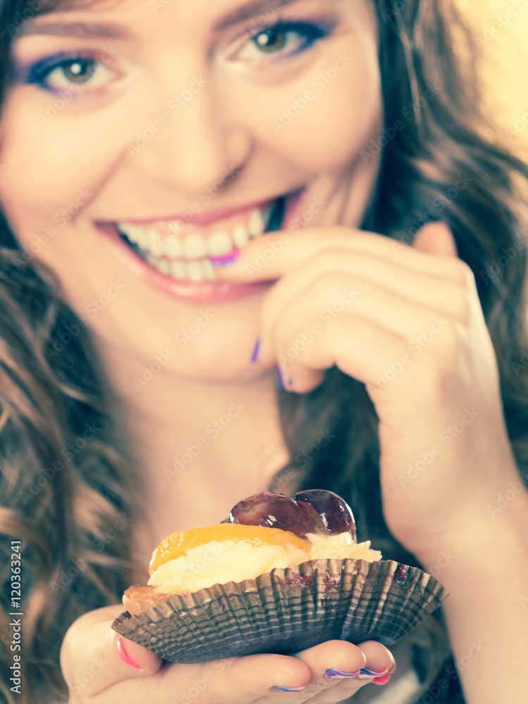 Closeup flirty woman eating fruit cake Closeup flirty woman eating fruit cake