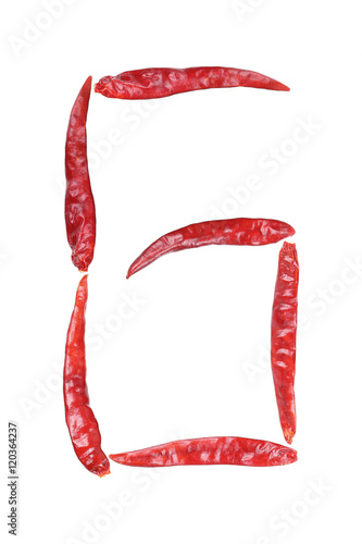 capital letter G by dry chili isolated on white