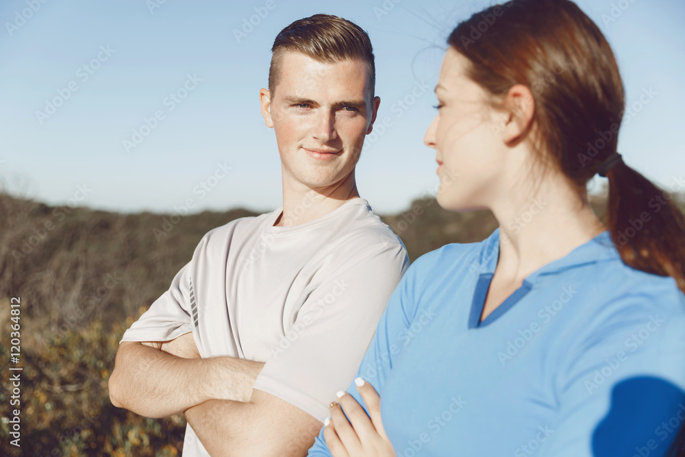 Young couple on beach in sportwear Young couple on beach in sportwear