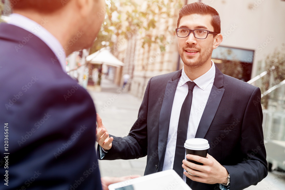 Fototapeta premium Two businessmen talking outdoors