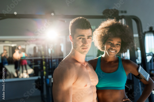 Athletic man and  afro american woman posing in gym. Couple that trains together stays together © Myvisuals