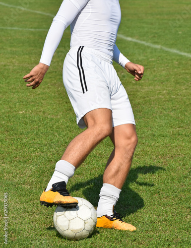 Fototapeta Naklejka Na Ścianę i Meble -  Soccer player with a ball