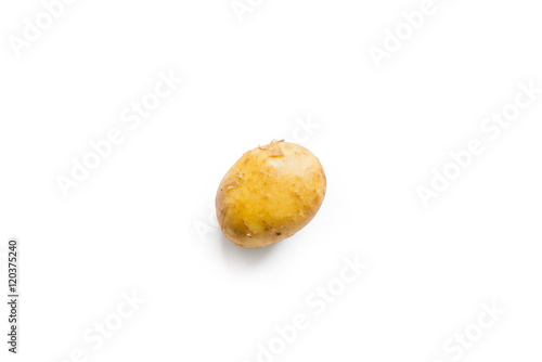 beautiful small rounded whole organic potato with the peel isolated on a white background seen from above