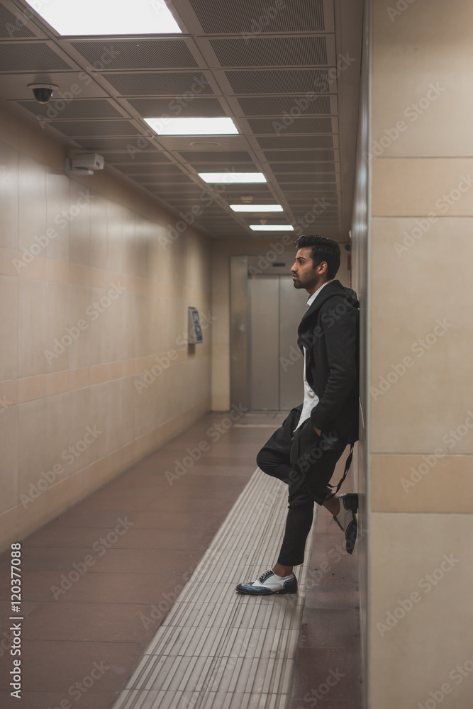 Fototapeta premium Handsome Indian man posing in a metro station