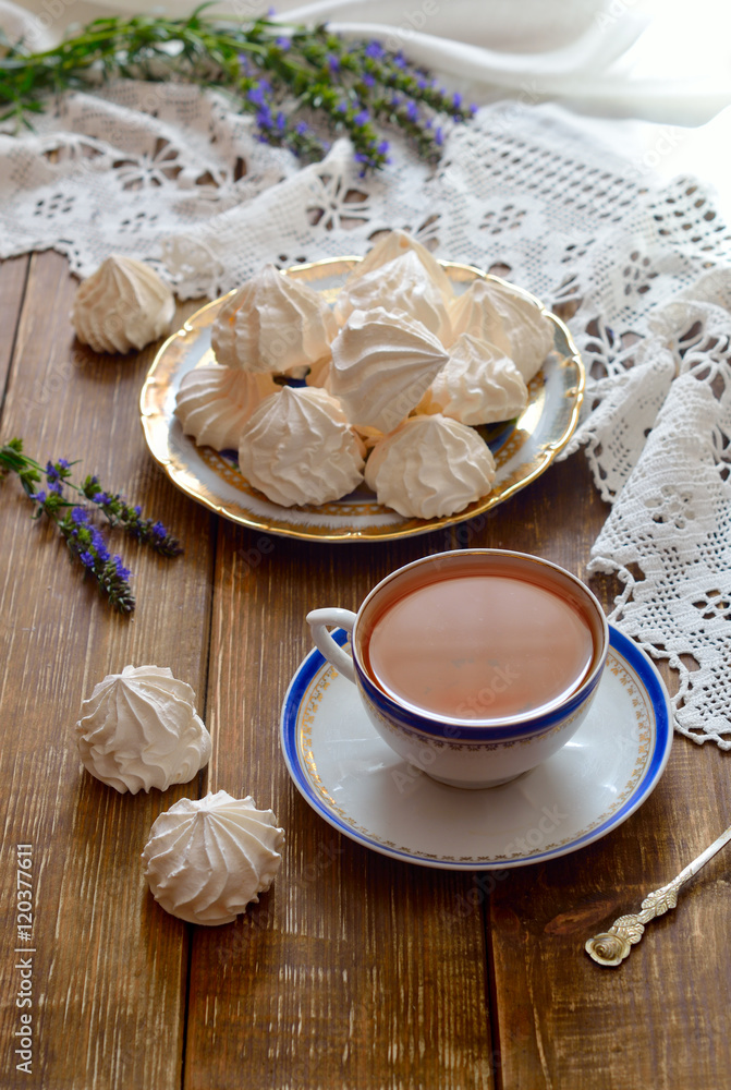 A bowl of home-made meringues with tea. A bowl of home-made meringues with tea.