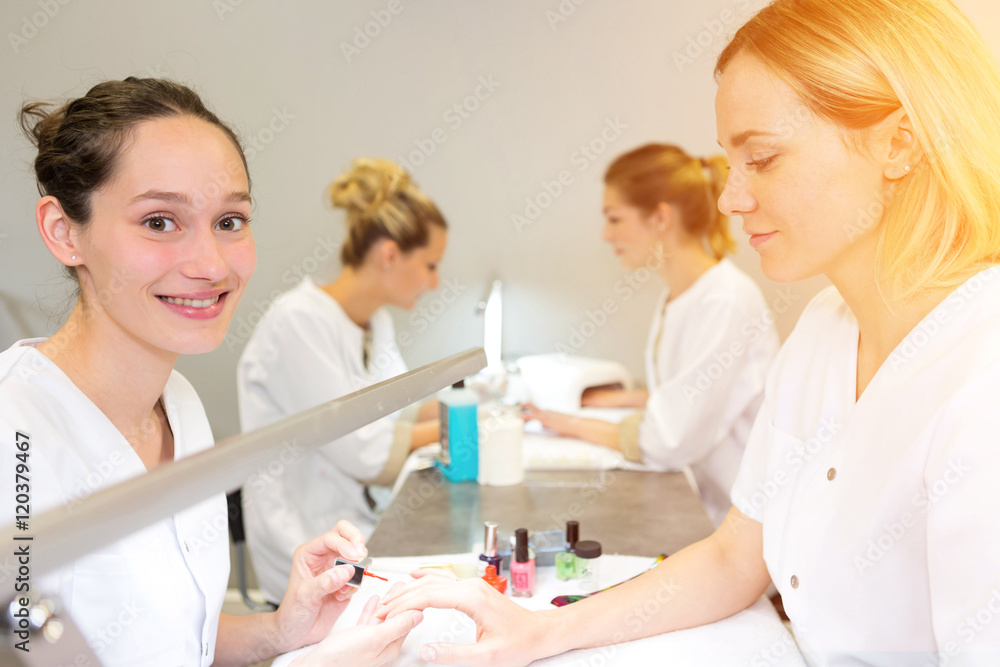 Young attractive beautician students practising during courses Young attractive beautician students practising during courses