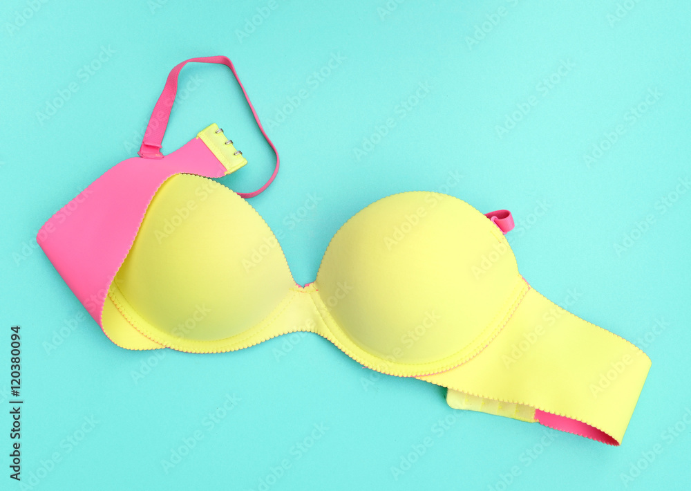 Summer concept, Yellow bra on blue background. (Pop art style) Summer concept, Yellow bra on blue background. (Pop art style)