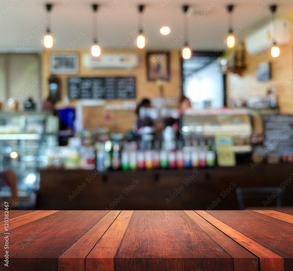 Empty brown wooden table surface and Coffee shop interior blur background with bokeh image, for product display montage,can be used for montage or display your products.