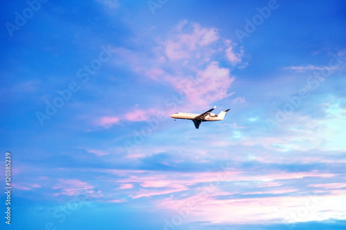 airplane in a beautiful sunset sky. Travel  vacation concept
