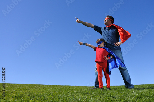 Superhero father shows his daughter how to be  a superhero