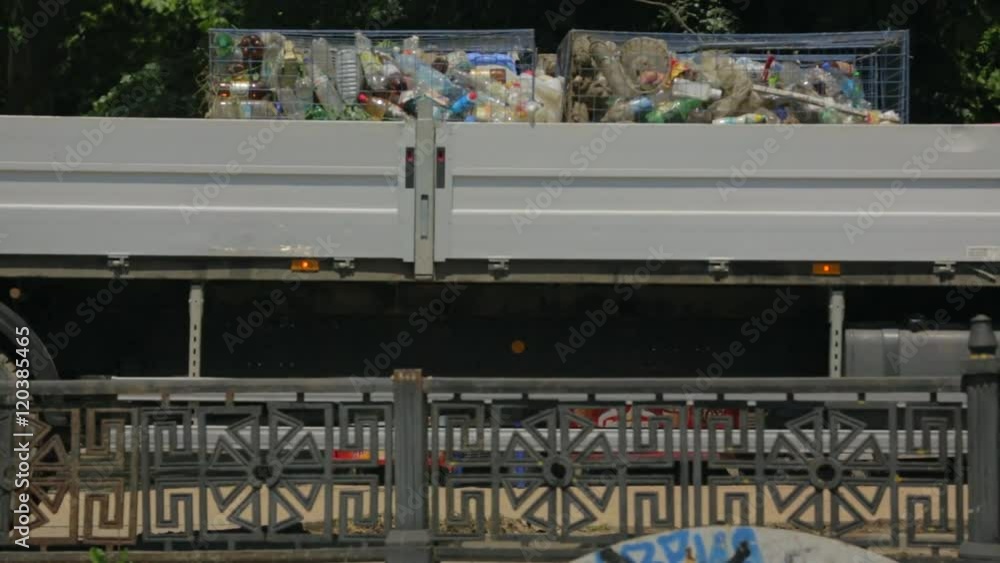 Truck With Garbage Driving Along River Bank Truck With Garbage Driving Along River Bank