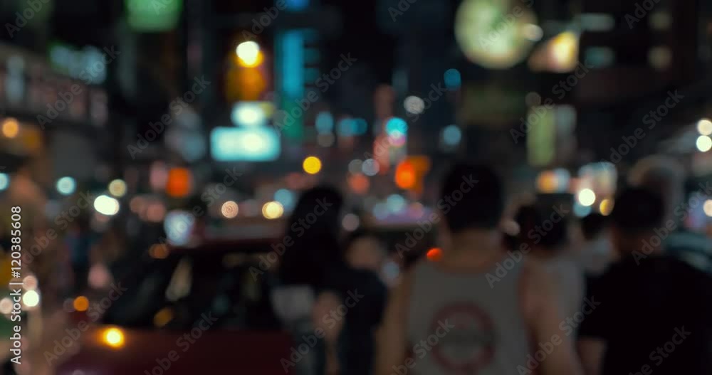 Defocused shot of people and car traffic in the street of Bangkok at night, Thailand. Colorful blurred city lights, faces unidentified Defocused shot of people and car traffic in the street of Bangkok at night, Thailand. Colorful blurred city lights, faces unidentified