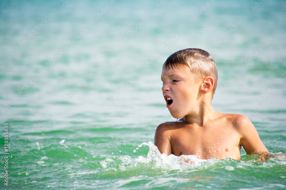 boy emerging from the sea water