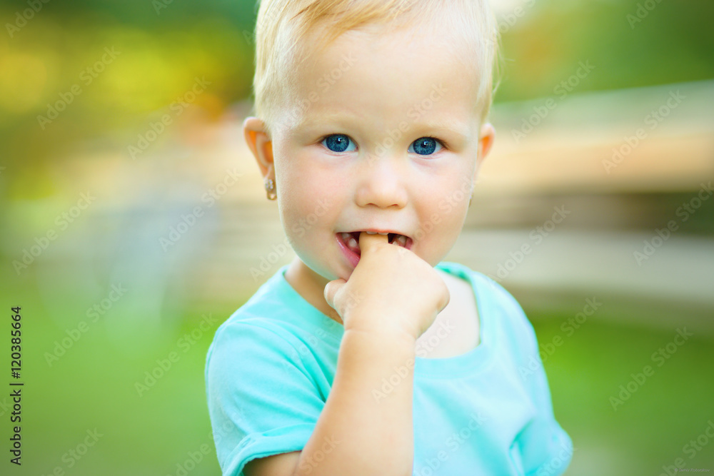 Portrait of a little girl with finger in her mouth Portrait of a little girl with finger in her mouth