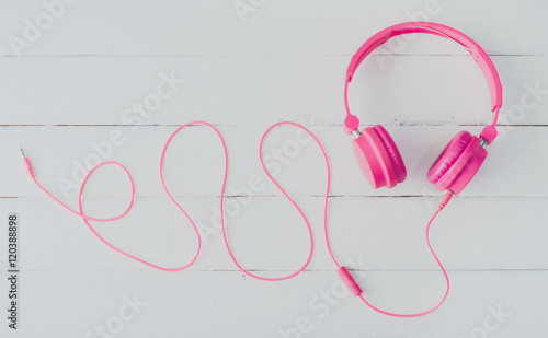 Pink headphones on the wooden floor