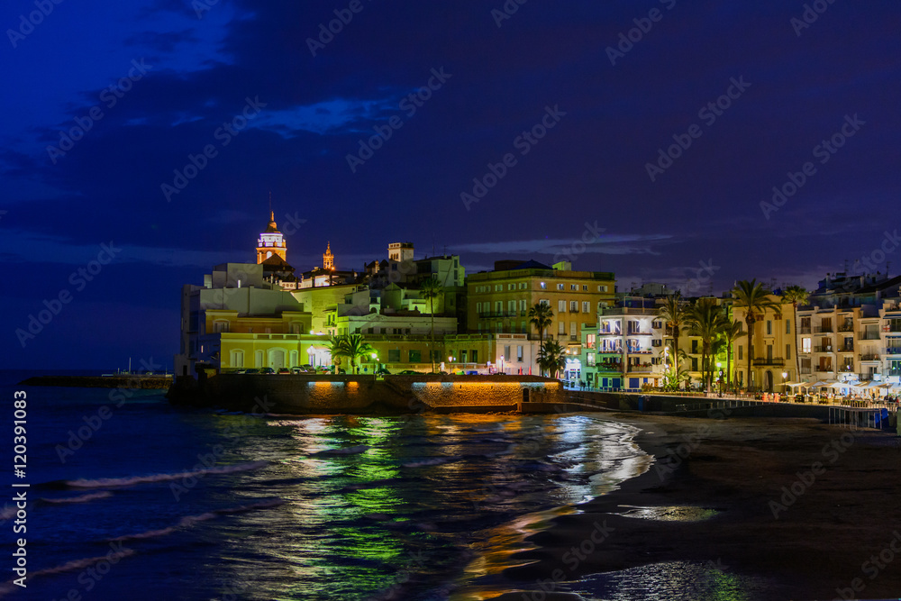 Sitges, Spain - June 10: Illuminated sea shore and buildings on