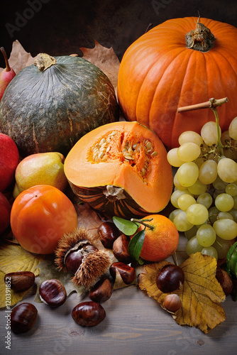 Still life, pumpkins and autumn fruits: grapes, apples, pears, chestnuts, persimmons, walnuts, hazelnuts 