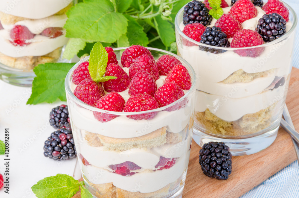 Tiramisu in a glass with coffee sponge cake and fresh berries Tiramisu in a glass with coffee sponge cake and fresh berries