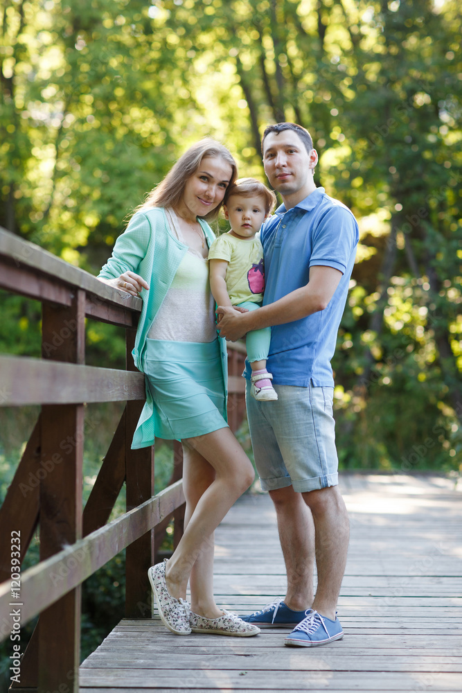 Portrait of happy family on a wooden bridge Portrait of happy family on a wooden bridge