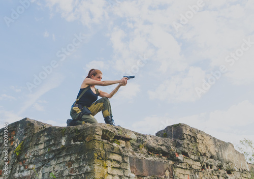 girl in a governmental form to aim with a gun