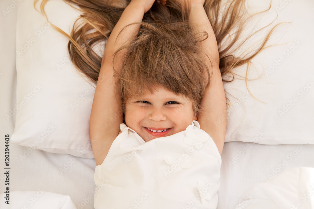 Fototapeta premium Toddler girl laying on bed