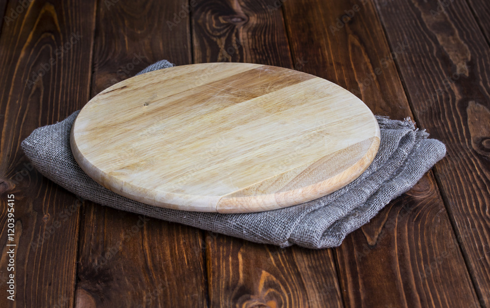 Round chopping board on a wooden table