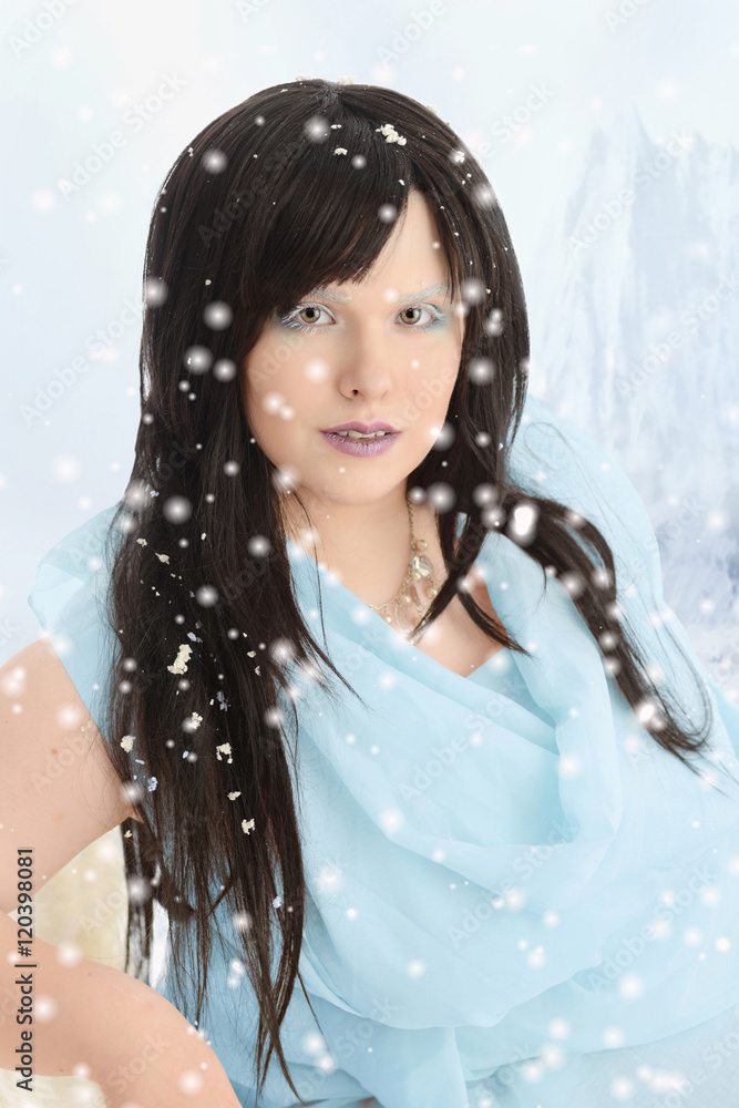 portrait of woman in blue dress with it snowing portrait of woman in blue dress with it snowing