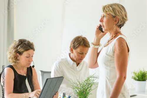 female manager using phone in office