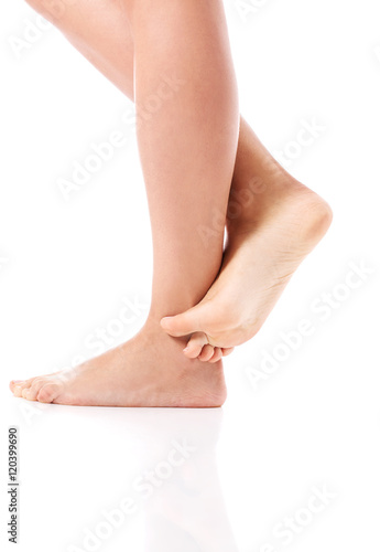 Women's feet on white background. © Piotr Marcinski
