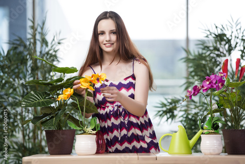 Young woman taking care of home plants