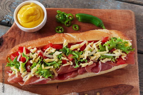 sandwich baguette ham jamon cheese with tomato and herbs