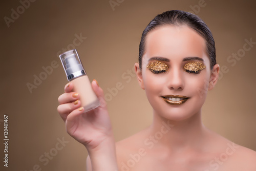 Woman with bottle of skincare cream