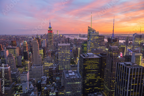 Bright golden pink sunset view of the Midtown Manhattan New York City skyline looking south 
