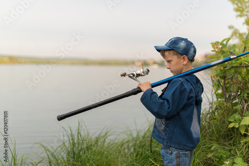 child on a summer fishing on the shore