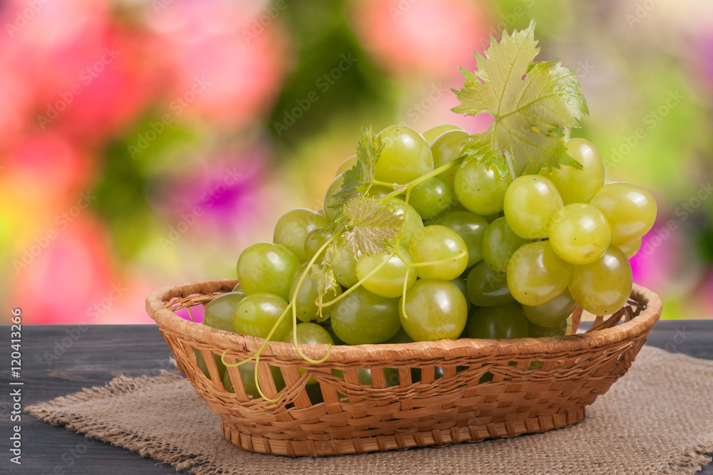bunch of ripe green grapes on a wooden table with blurred background bunch of ripe green grapes on a wooden table with blurred background