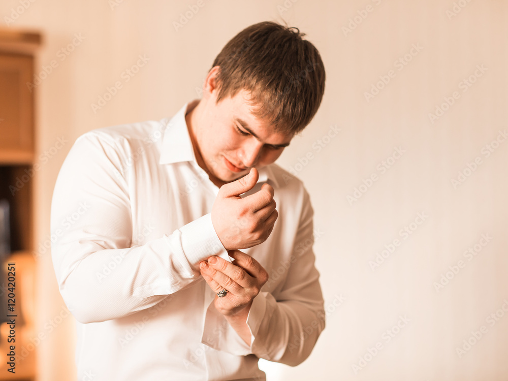 Handsome confident groom preparing for wedding Handsome confident groom preparing for wedding
