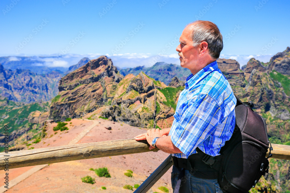 Caucasian man viewing rocky mountains in landscape Caucasian man viewing rocky mountains in landscape